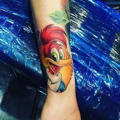 a tattoo on the leg of a person with an angry bird design on it's arm