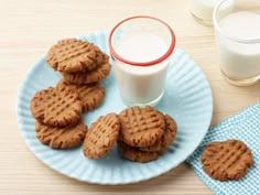 some cookies on a plate next to a glass of milk