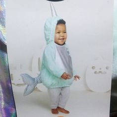 a little boy in a costume that looks like a fish