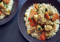 two plates with rice, carrots and chicken on them sitting next to each other