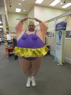 a man dressed as a sumo wrestler posing for the camera in an office cubicle