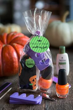 a table with pumpkins, nail polish and other items for halloween decorations on it