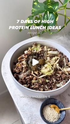 a bowl filled with food sitting on top of a counter next to a potted plant