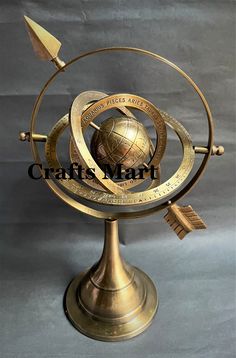 a golden globe with an arrow on top