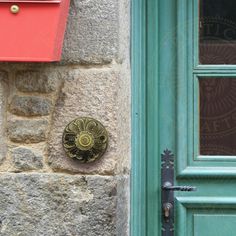 a green door with a red mailbox next to it