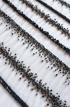 black beaded trim on white fabric