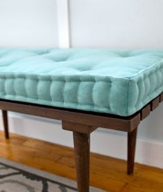 a blue mattress sitting on top of a wooden table