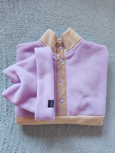 A lilac and beige handmade high neck fleece pullover. This fleece features a beige polycotton placket with lilac poppers to match the lilac upper fleece fabric. It can be finished with an elasticated drawcord hem to conveniently adjust the length, style and fit with just one pull or a standard hem finish. This design is made to order in the following unisex sizes: S M L XL * Please note, this item is for the fleece pullover only. These fleeces are a boxy, slightly oversized fit. Please allow 5 working days from date of order to dispatch. I will send your fleece via 1st class delivery. Please let me know if you have any questions :) Chelsea x Purple Buttoned Winter Tops, Handmade Gift Wrap, Dog Walker, Fleece Sweater, Dog Print, Fleece Fabric, Pullover Sweatshirt, Sweat Shirt, Gender Neutral