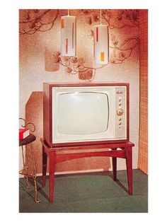 an old tv sitting on top of a wooden stand in front of a wall with two lights