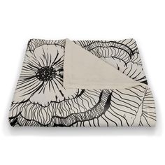 the black and white flower design on this blanket is made from organic material, which has been