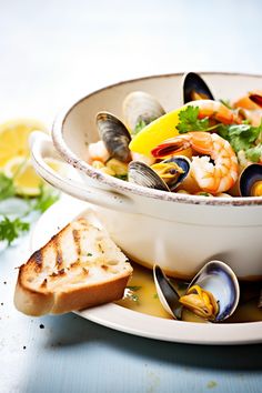 a white bowl filled with clams and bread