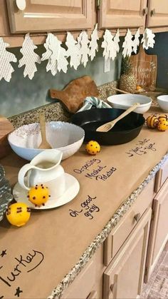 the kitchen counter is covered with bowls and plates