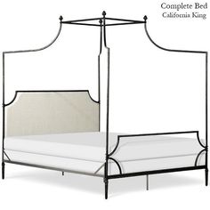 an iron bed frame with white linens and black metal posts, complete with the california king mattress