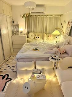 a bed room with a neatly made bed and lots of stuffed animals on the floor