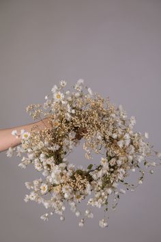 a person holding a bunch of flowers in their hand