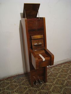 an upright piano sitting in front of a wall