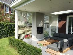 an outdoor living area with couches and tables