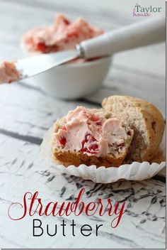 a close up of a muffin on a plate with strawberry cream in the middle