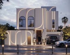 a large white building with lots of windows on the front and side of it at night