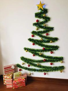 a green christmas tree with presents under it