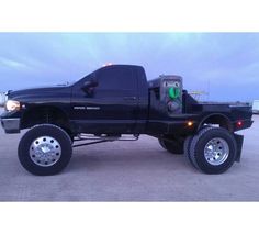 a large black truck parked in a parking lot