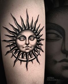 a sun tattoo on the arm with a woman's face in the center and an image of a man's face behind it