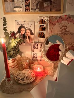 a table topped with pictures and candles