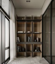 an empty room with bookshelves and glass doors