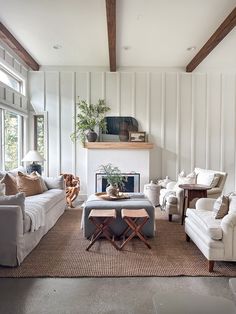 a living room filled with furniture and a fire place in the middle of a room