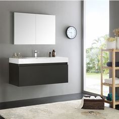 a bathroom with a sink, mirror and towel rack