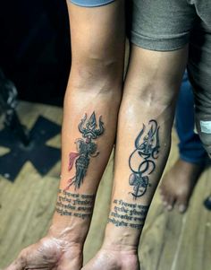 two people with matching tattoos on their arms