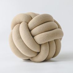 a knoted cushion sitting on top of a white surface