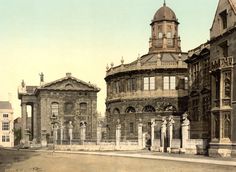 an old photo of some buildings in the middle of town