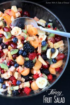 a fruit salad is shown in a bowl with a spoon on the side that says fancy fruit salad