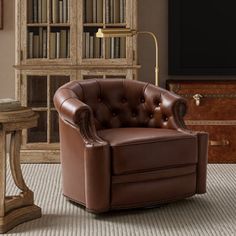 a brown leather chair sitting in front of a book shelf filled with lots of books