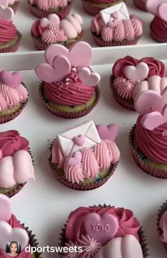 cupcakes decorated with pink and white frosting in the shape of heart shapes