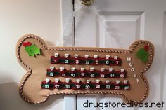 a dog bone shaped door hanger with numbers and candy canes on it's side