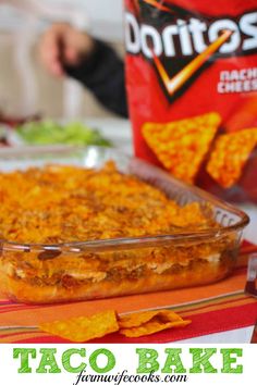 this taco bake has been made with tortilla chips and is ready to be eaten