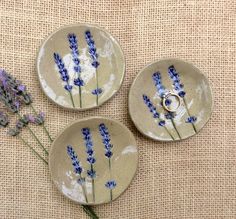 three small plates with lavender flowers on them