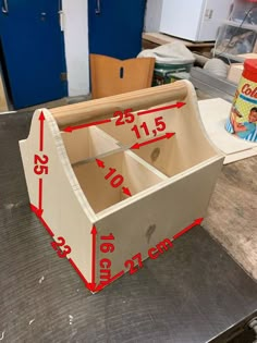 a wooden box with measurements on it sitting on a table