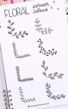 an open notebook with flowers and leaves drawn on it