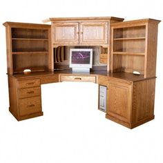 a computer desk with wooden cabinets and drawers