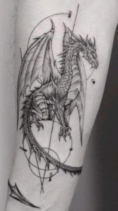 a black and white photo of a dragon tattoo on the right arm with geometric shapes around it