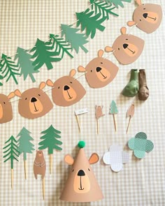 paper animals and trees on a table with cupcake toppers