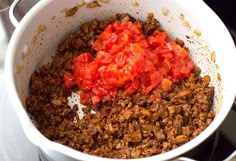 a white bowl filled with food sitting on top of a stove