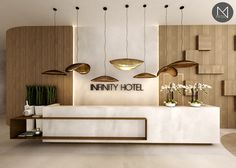 a hotel lobby with modern decor and lighting above the reception desk, as well as hanging planters