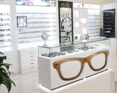 the inside of a store with glasses on display