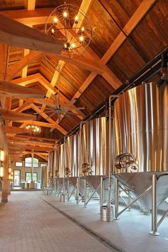 the inside of a building with many metal tanks