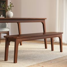 a wooden bench sitting on top of a carpeted floor