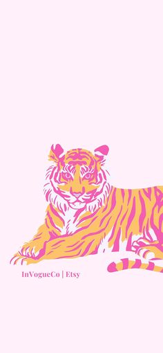 an orange and pink tiger laying down on the ground